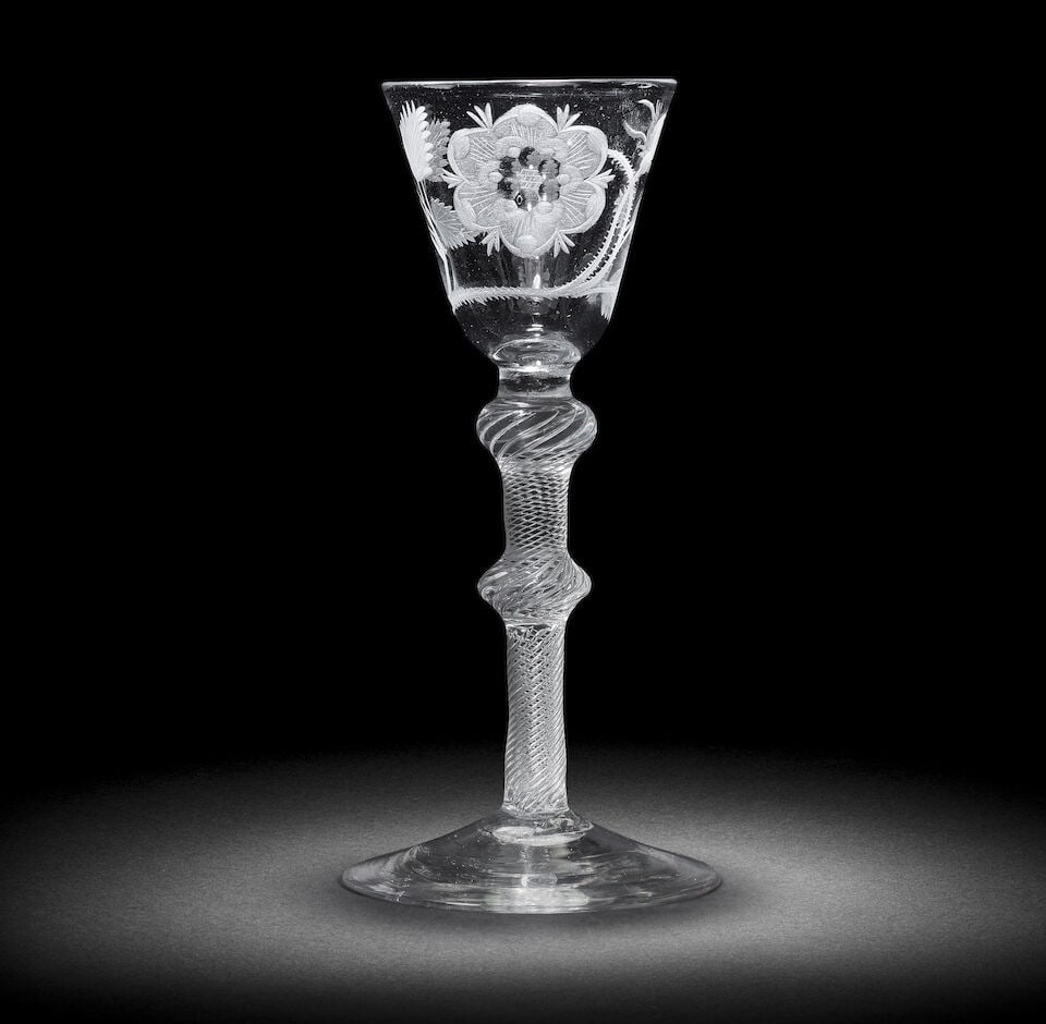 A Jacobite engraved airtwist wine glass, circa 1750: A Jacobite engraved airtwist wine glass, circa 1750 The round funnel bowl with a six-petalled heraldic rose on a thorny stem with one closed bud, an oak leaf to the reverse, on a multi-spiral airtwist