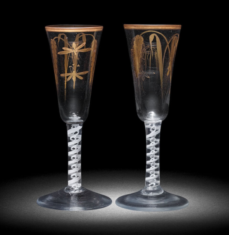 A near pair of Giles gilded opaque twist ale glasses, circa 1765: A near pair of Giles gilded opaque twist ale glasses, circa 1765 Decorated in the London workshop of James Giles, the tall round funnel bowls gilt with crossed ears of barley, two insects in flight to
