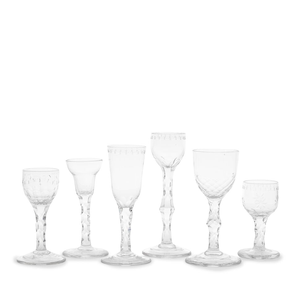 Five good facet stem wine glasses and an ale glass, circa 1770-90: Five good facet stem wine glasses and an ale glass, circa 1770-90 Three with hexagonal faceted stems, one perhaps a cordial glass, with a cup-shaped bowl engraved with an 'OXO' border, on an unusually