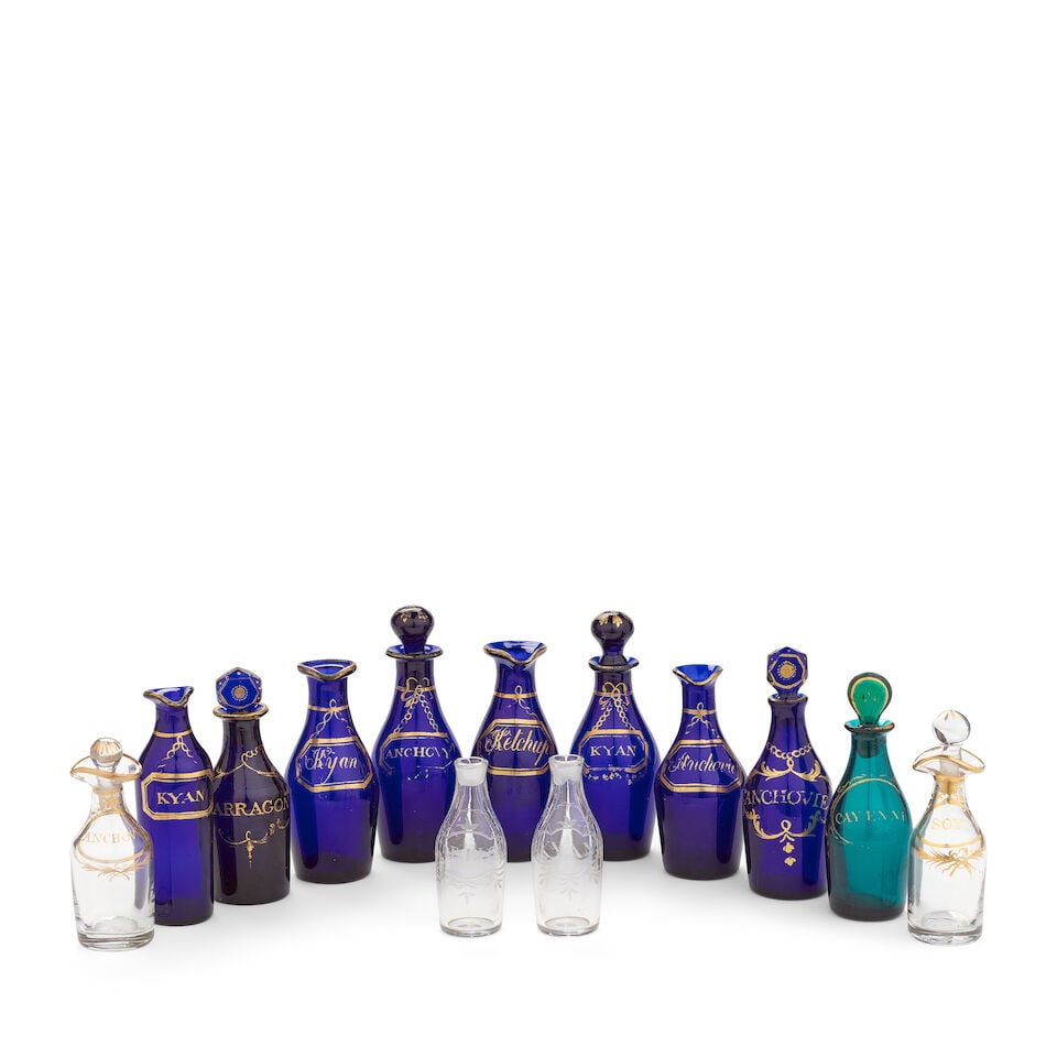 Thirteen glass cruet and condiment bottles, late 18th and early 19th century: Thirteen glass cruet and condiment bottles, late 18th and early 19th century Of shouldered form, comprising eight examples in deep cobalt-blue glass with gilt labels hung from chains, including a pair