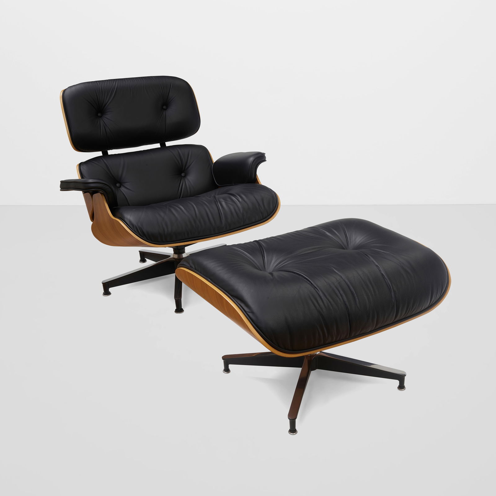 CHARLES EAMES (1907-1978) & RAY EAMES (1912-1988) 670 Lounge Chair and 671 Ottomandesigned 1956,...: CHARLES EAMES (1907-1978) & RAY EAMES (1912-1988) 670 Lounge Chair and 671 Ottoman designed 1956, produced circa 2020 laminated walnut, leather, with Herman Miller tags on underside of both height of