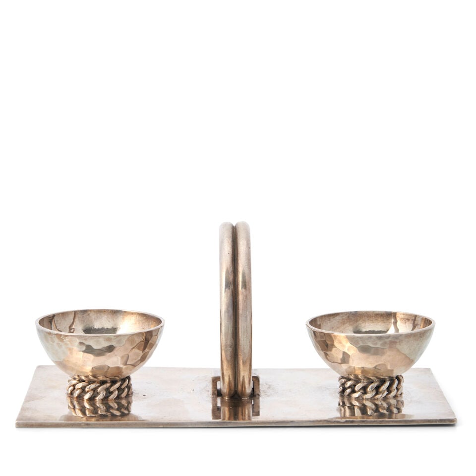 JEAN DESPRES (1889-1980) DOUBLE SALT CELLAR France, circa 1925, silverplate, with stamped hallma...: JEAN DESPRES (1889-1980) DOUBLE SALT CELLAR France, circa 1925, silverplate, with stamped hallmark and incised 'J. Despres,' ht. 2 1/4, base 5 1/4 x 2 7/8 in. For further information on this lot
