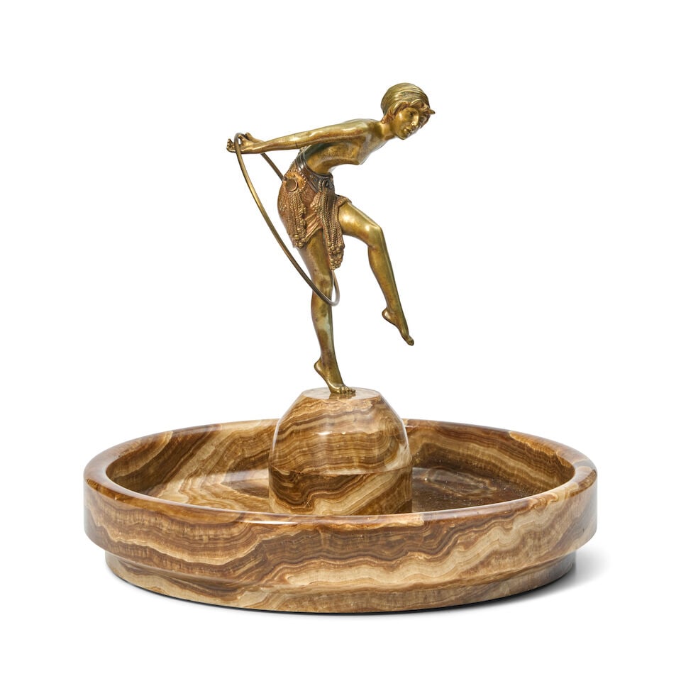 DEMETRE CHIPARUS (1886-1947) 'HOOP DANCER' SCULPTURE France, circa 1925, gilded and patinated br...: DEMETRE CHIPARUS (1886-1947) 'HOOP DANCER' SCULPTURE France, circa 1925, gilded and patinated bronze, onyx, underside of one foot stamped '146,' onyx faintly inscribed 'Chiparus,' sculpture ht. 7 3/4,