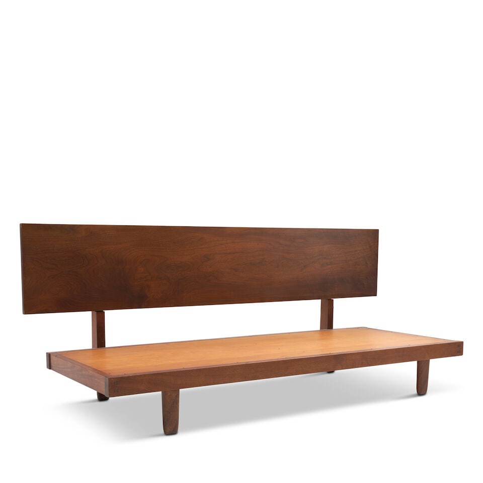 DAYBED IN THE STYLE OF GEORGE NAKASHIMA circa 1965, walnut, plywood, unmarked, ht. 33 1/4, seat ...: DAYBED IN THE STYLE OF GEORGE NAKASHIMA circa 1965, walnut, plywood, unmarked, ht. 33 1/4, seat ht. (not including cushion) 10, backboard lg. 84, dp. 33, frame 76 1/2 x 30 in. Footnotes: Provenance Pu