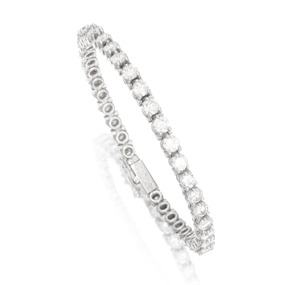 CARTIER: BRACELET DIAMANTS: CARTIER: BRACELET DIAMANTS De forme ligne, serti de diamants de taille brillant, signé Cartier, numéroté, poinçons français pour l'or 18K (750 ‰) et pour le platine (850