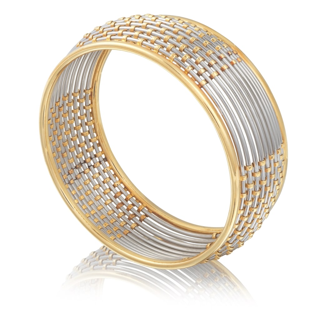 CARTIER: BRACELET JONC OR ET ACIER: CARTIER: BRACELET JONC OR ET ACIER Composé de fils ronds en acier réhaussé d'un tissage en or jaune, signé Cartier, numéroté, poinçon français d'import pour l'o