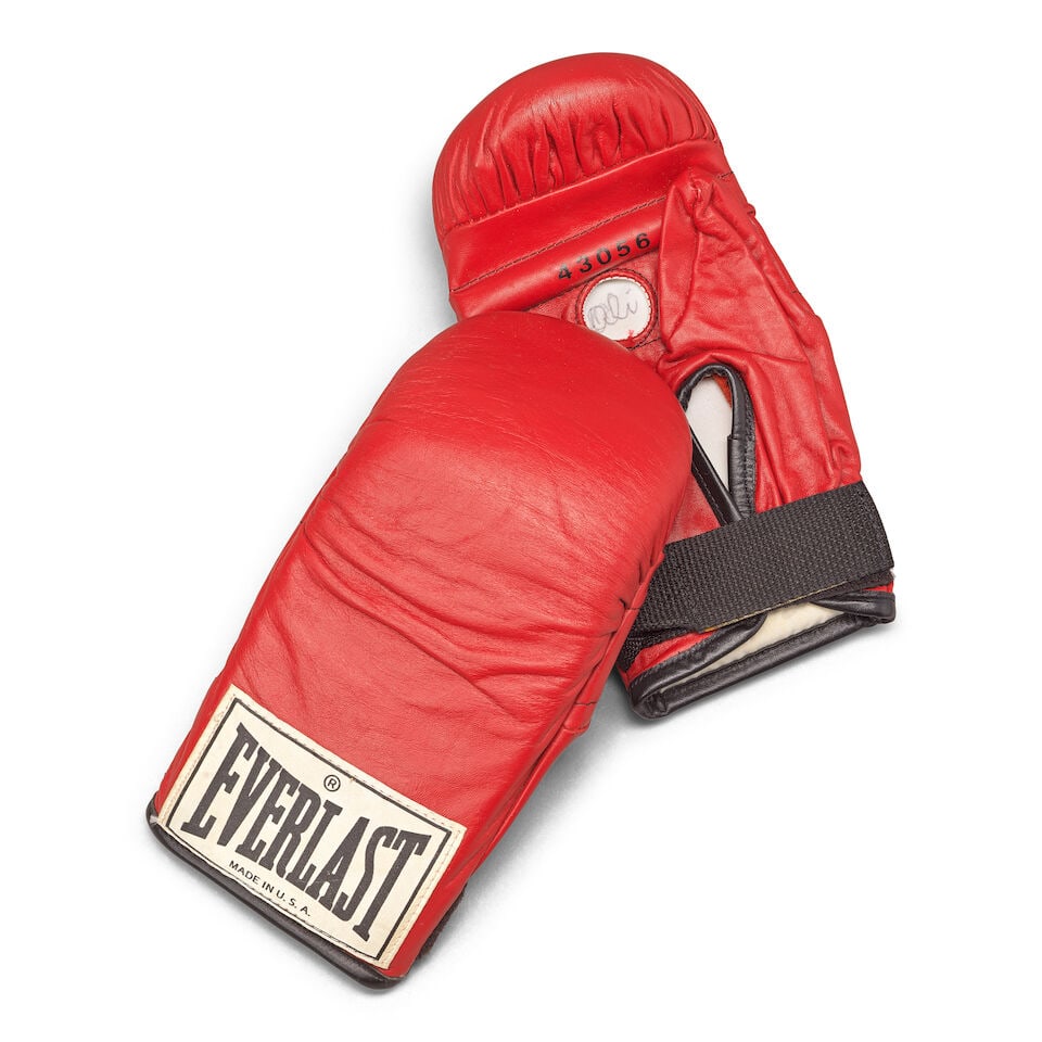 Muhammad Ali post-career training gloves: Muhammad Ali post-career training gloves A pair of training gloves used by Ali Everlast model 43056, made post 1981, palm-side opening of each glove inscribed 'Ali' and each inscribed and dated 'For W