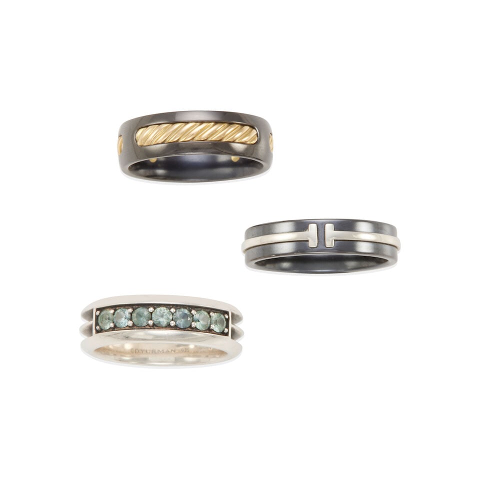 GROUP OF THREE 18K GOLD, STERLING SILVER, TITANIUM, AND SAPPHIRE RINGS: GROUP OF THREE 18K GOLD, STERLING SILVER, TITANIUM, AND SAPPHIRE RINGS • TIFFANY & CO.: Titanium and sterling silver band ring, size 11 • DAVID YURMAN: Titanium and 18k yellow gold band ri