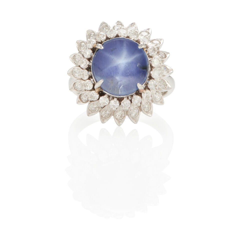 PLATINUM, STAR SAPPHIRE AND DIAMOND RING: PLATINUM, STAR SAPPHIRE AND DIAMOND RING • Platinum • Numerous round diamonds weighing approximately 0.90 - 1.00 carat total • 1 round cabochon star sapphire measuring approximately