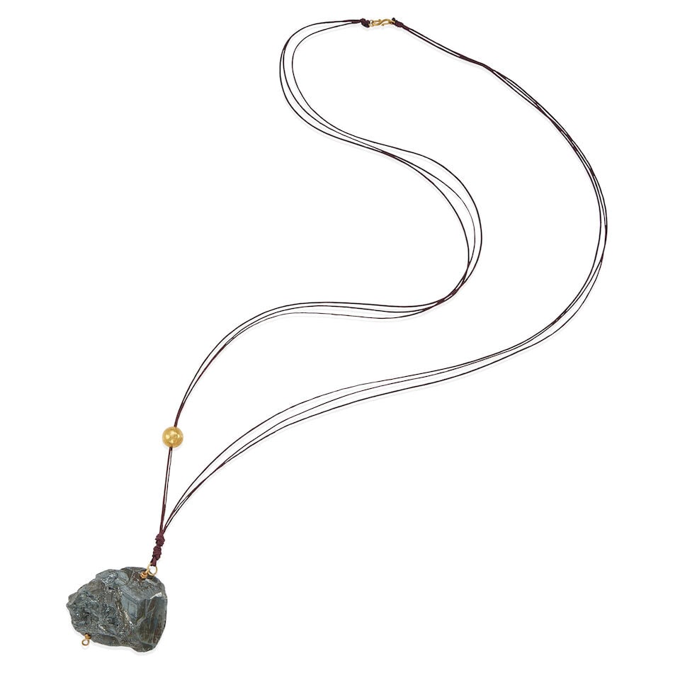 18K GOLD AND BLACK ROCK PENDANT NECKLACE: 18K GOLD AND BLACK ROCK PENDANT NECKLACE • 18k yellow gold • 1 rough unfashioned rock measuring 51.00 x 45.00 x 27.00 mm in diameter • 18k spherical gold bead measures 11.90 mm in