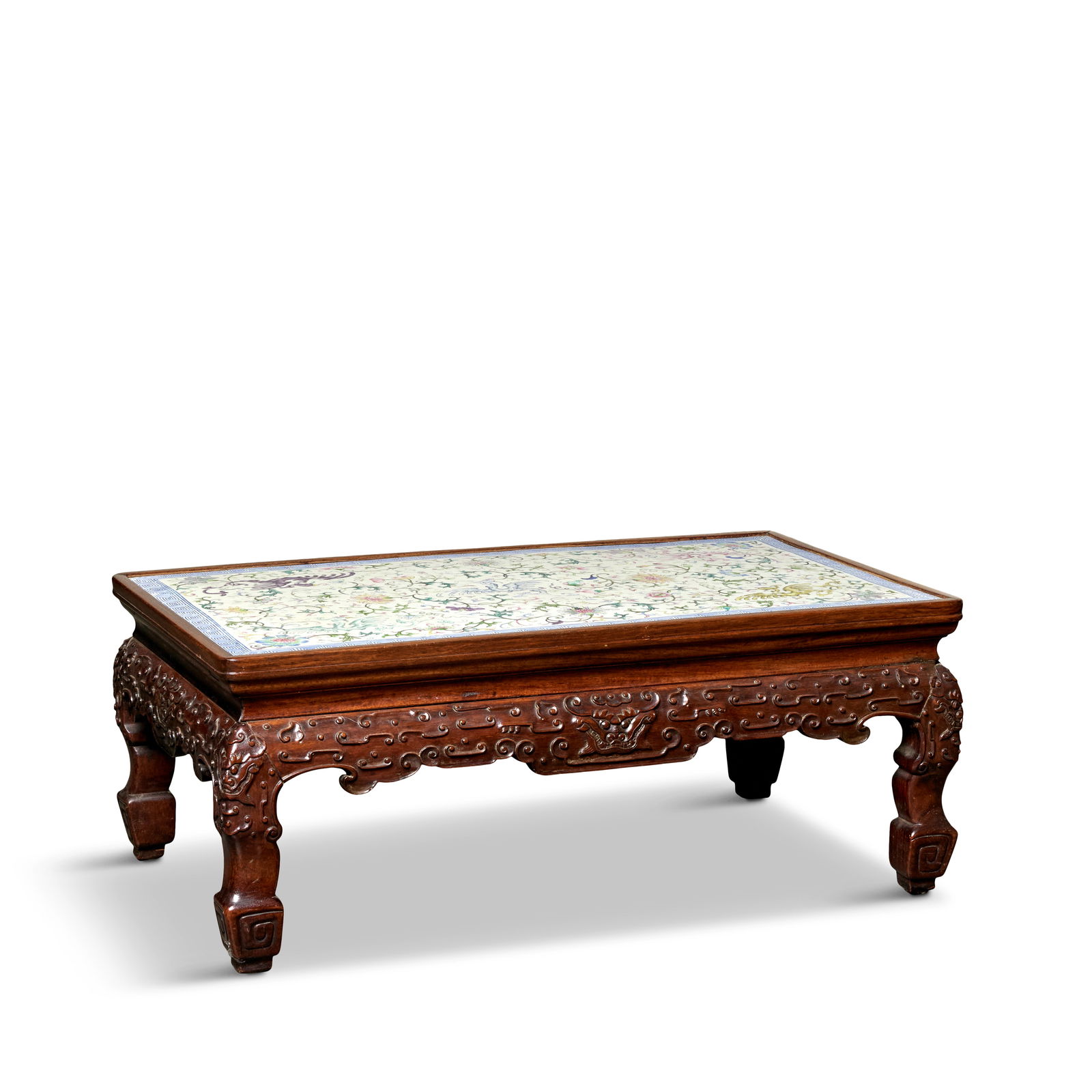 A FAMILLE ROSE ENAMELLED PORCELAIN MOUNTED HUANGHUALI RECTANGULAR LOW TABLE, KANGZHUO Jiaqing: A FAMILLE ROSE ENAMELLED PORCELAIN MOUNTED HUANGHUALI RECTANGULAR LOW TABLE, KANGZHUO Jiaqing The rectangular porcelain panel set into a water-stopping rectangular frame of mitred, mortise and tenon c