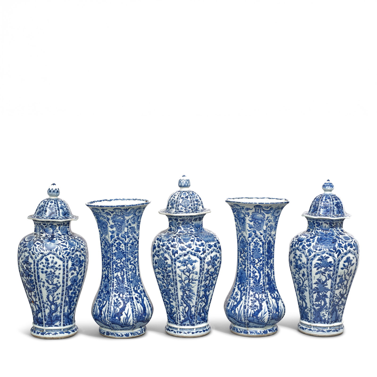 A BLUE AND WHITE FIVE-PIECE GARNITURE Kangxi period (5): A BLUE AND WHITE FIVE-PIECE GARNITURE Kangxi period Comprising three slender baluster vases with covers and two gu-shaped beaker vases, each of octagonal outline and painted in deep tones of cobalt bl