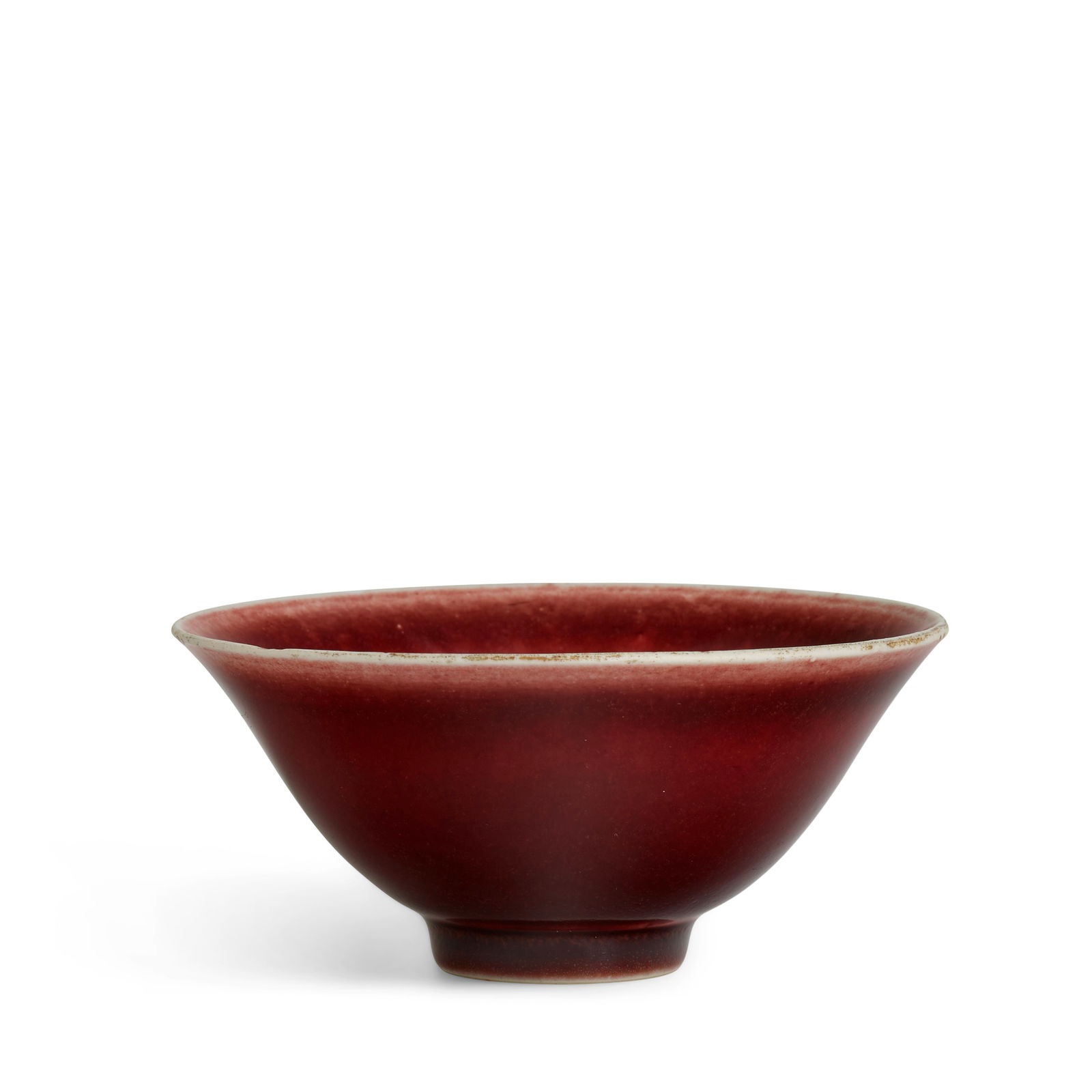 A RARE COPPER-RED-GLAZED BOWL Four-character incised Xuande mark, Ming Dynasty: A RARE COPPER-RED-GLAZED BOWL Four-character incised Xuande mark, Ming Dynasty The deep rounded sides rising to a gently flared rim and supported on a tapered foot, covered inside and out with a brill