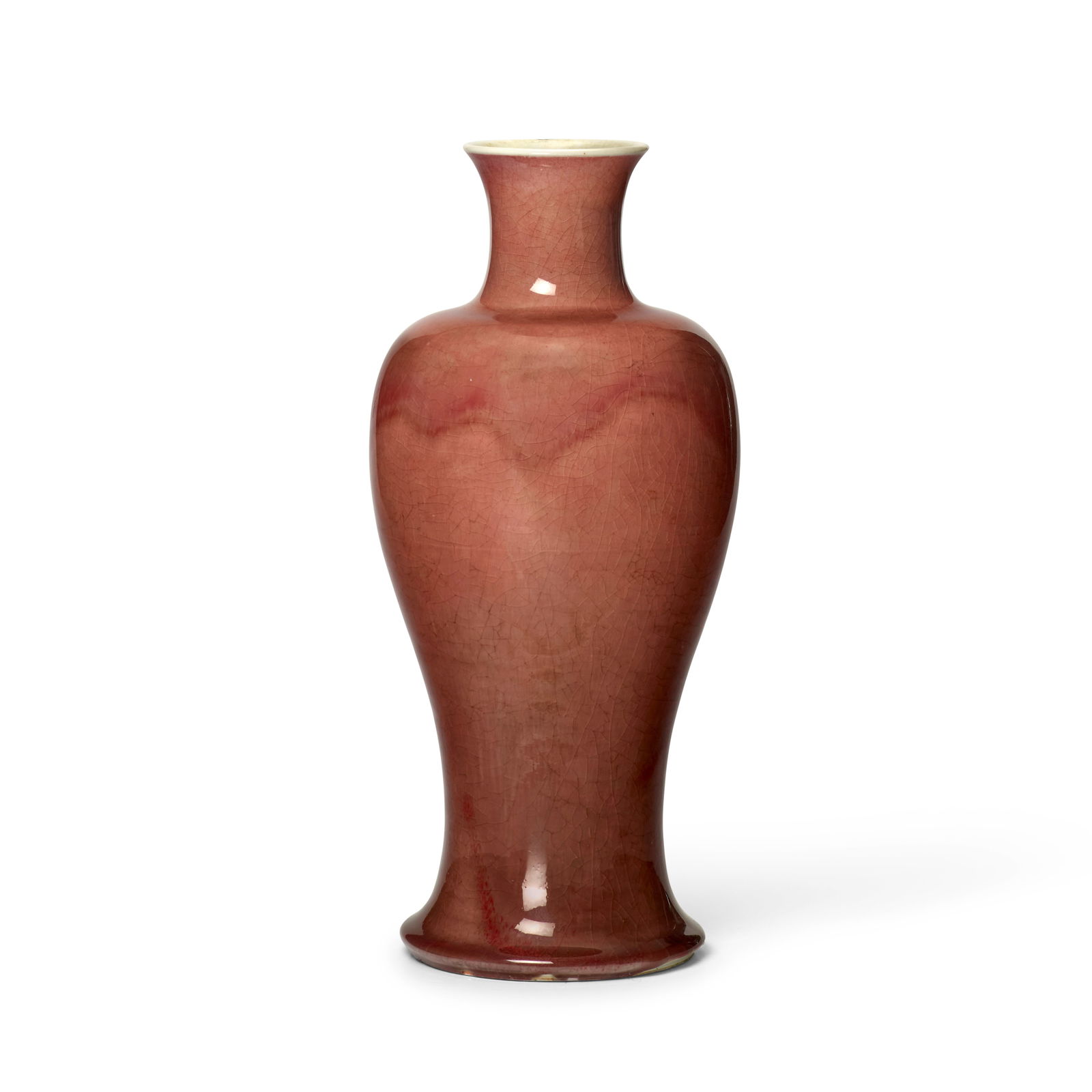 A COPPER-RED CRACKLE-GLAZED BALUSTER VASE 17th/18th century (wood stand): A COPPER-RED CRACKLE-GLAZED BALUSTER VASE 17th/18th century Elegantly potted, the thick translucent glaze of 'peachbloom' tones pooling at the splayed foot, the interior and base glazed white, the ung