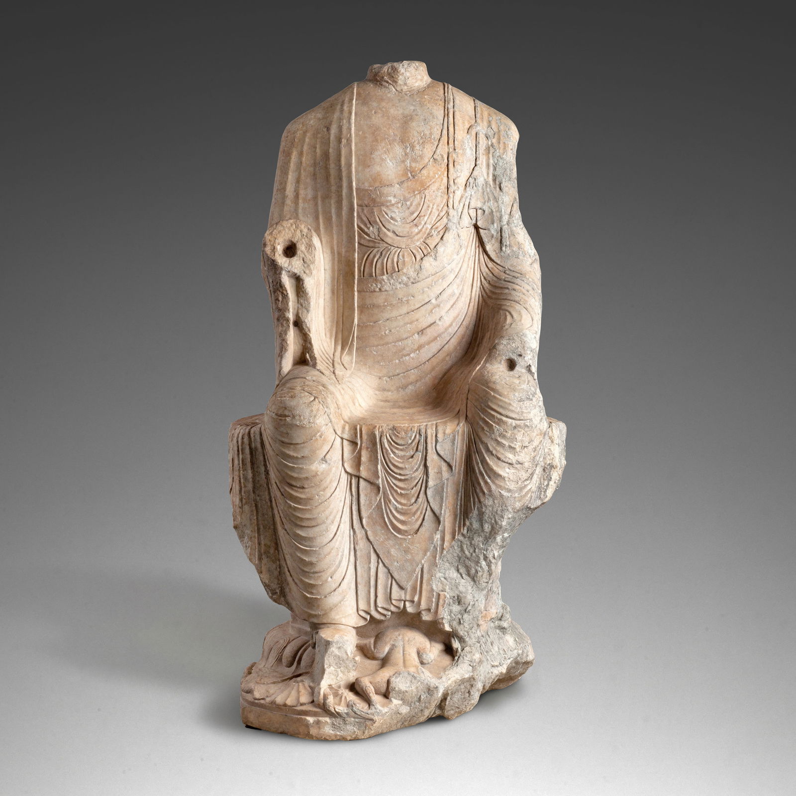 A VERY RARE AND IMPOSING MARBLE FIGURE OF MAITREYA Sui/early Tang Dynasty, 7th century: A VERY RARE AND IMPOSING MARBLE FIGURE OF MAITREYA Sui/early Tang Dynasty, 7th century Seated with both legs pendant in bhadrāsana, the right hand raised and left hand resting on his thigh, weari