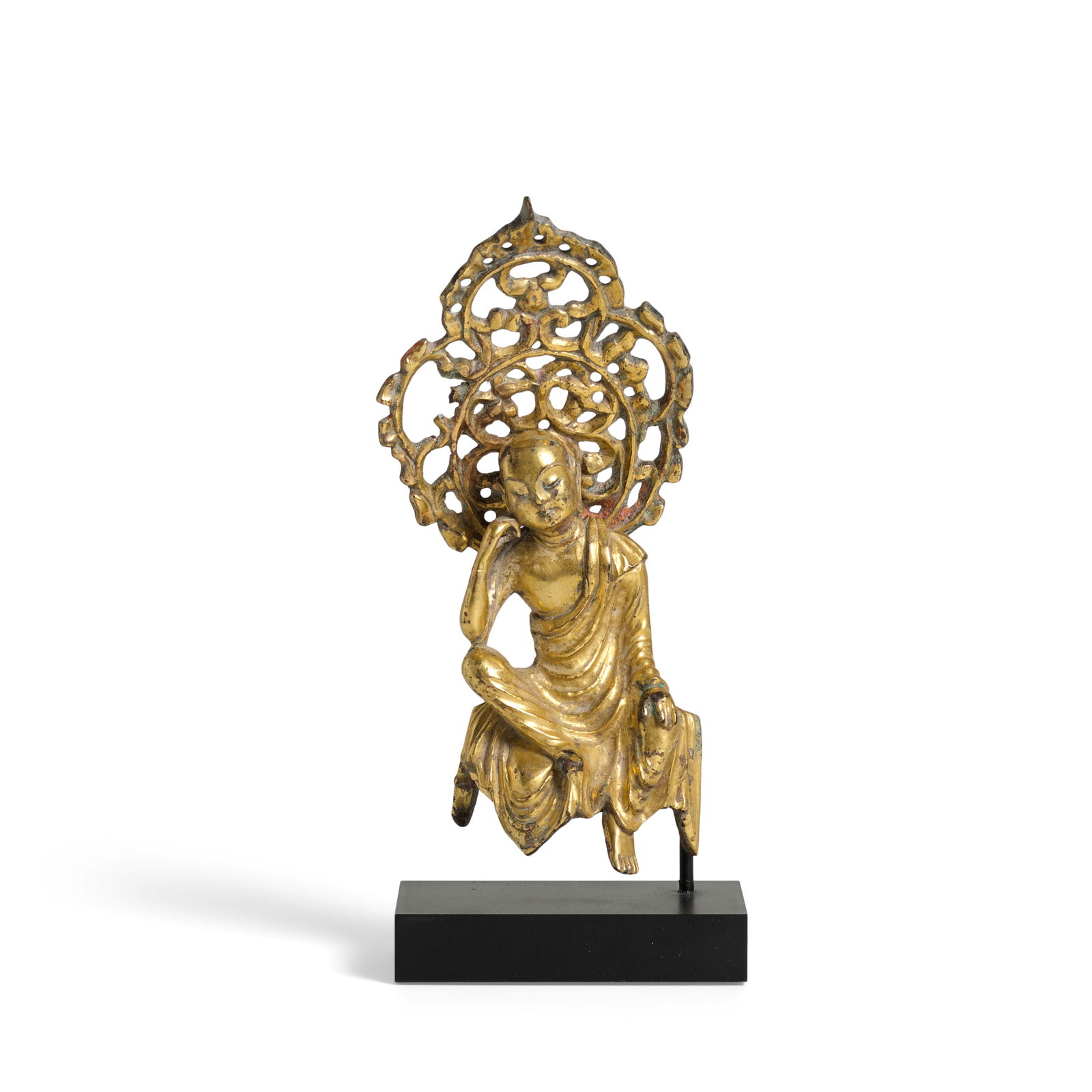 A SMALL GILT BRONZE FIGURE OF BODHISATTVA, DIZANG Tang Dynasty (fitted stand): A SMALL GILT BRONZE FIGURE OF BODHISATTVA, DIZANG Tang Dynasty The deity with downcast eyes and a deep contemplating expression, seated at ease with his left leg pendant and left hand resting on the k