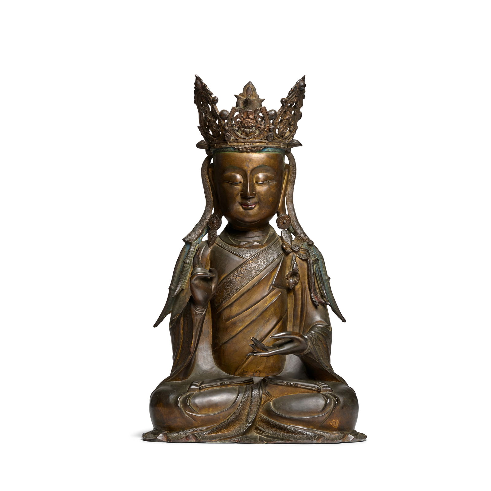 A BRONZE FIGURE OF GUANYIN 17th century: A BRONZE FIGURE OF GUANYIN 17th century Cast in the round and seated in padmasana with the right hand raised, the left hand possibly holding a vessel, the face with a benevolent expression with downca