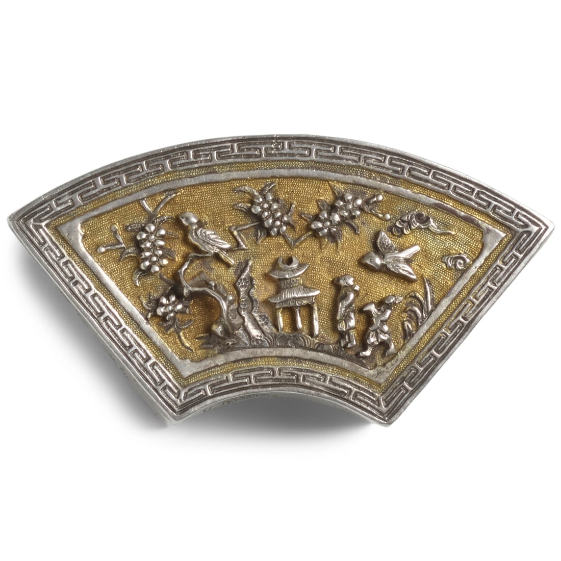A SMALL SILVER AND GILT FAN-SHAPED SILVER BOX AND COVER 18th century: A SMALL SILVER AND GILT FAN-SHAPED SILVER BOX AND COVER 18th century With heavily cast, hammered, chased and applied decoration, the extremely high-relief cover depicting a landscape scene with a scho