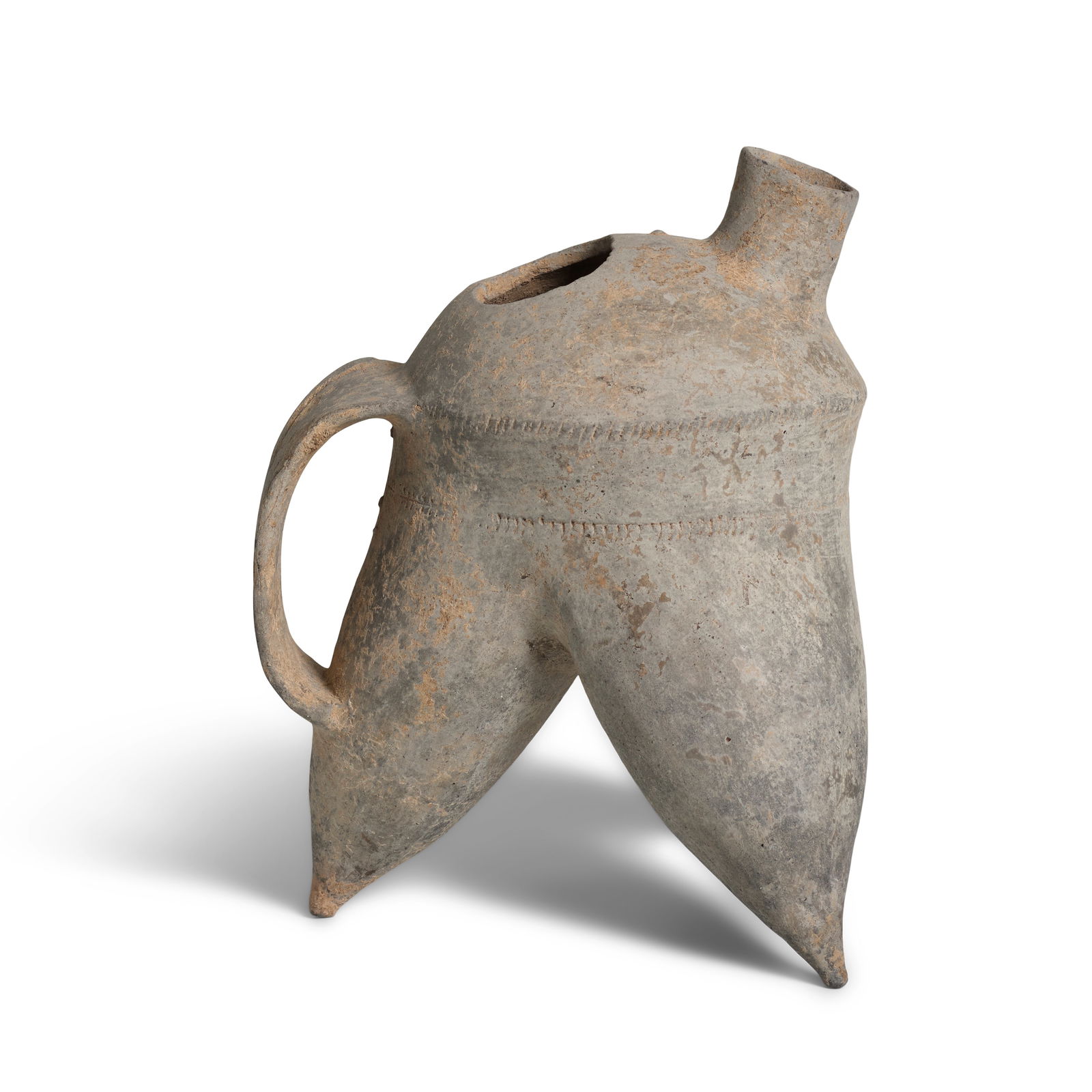 A NEOLITHIC GRAY POTTERY TRIPOD WATER VESSEL, HE Erlitou culture: A NEOLITHIC GRAY POTTERY TRIPOD WATER VESSEL, HE Erlitou culture The thinly potted body supported on cone-shaped legs with pointy feet, decorated with two rows of 'rope twist' around the waist, the do