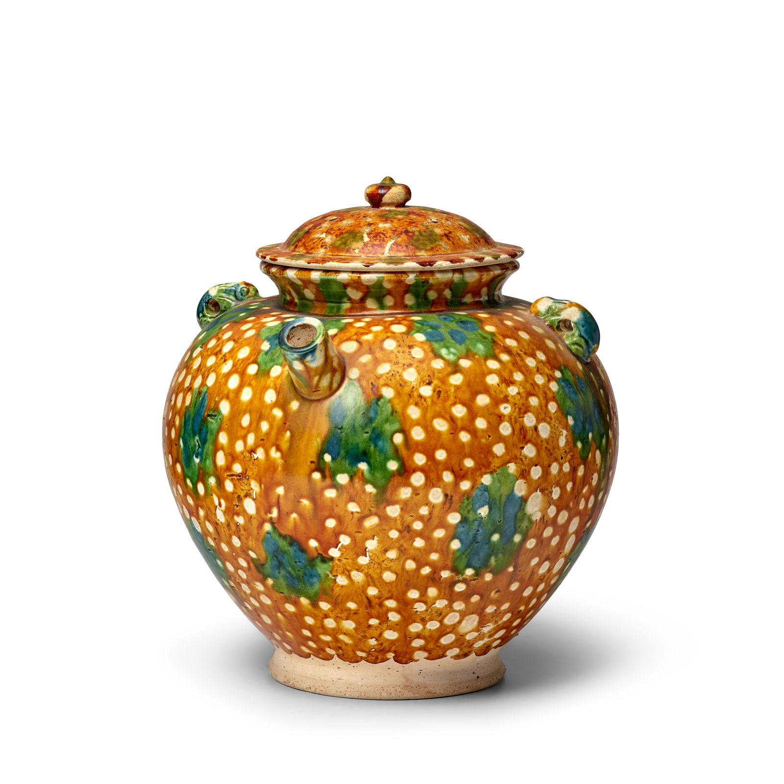 A RARE SANCAI-GLAZED POTTERY EWER AND COVER Tang Dynasty: A RARE SANCAI-GLAZED POTTERY EWER AND COVER Tang Dynasty The spherical body surmounting a short neck and everted rim, with a short cylinder spout to one side and a pair of 'rabbit' loop handles flanki