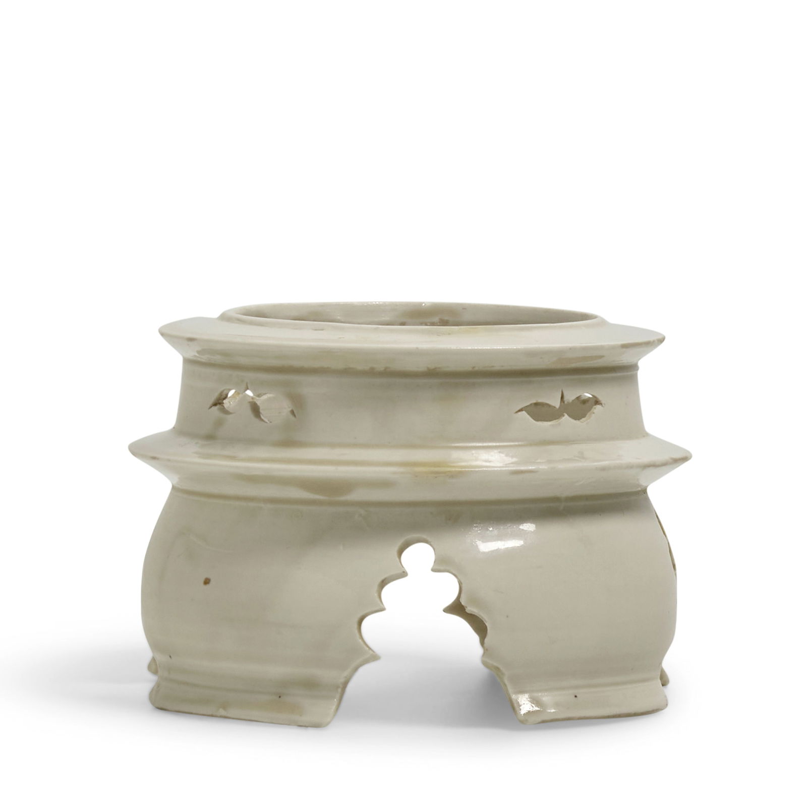 AN EXTREMELY RARE DINGYAO STAND Northern Song Dynasty: AN EXTREMELY RARE DINGYAO STAND Northern Song Dynasty The upper register with four florets opening between wedged borders, the lower register with four pagoda-shaped openings separating the slightly b