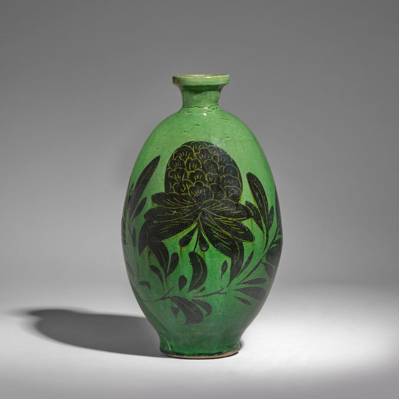 A RARE CIZHOU GREEN-GLAZED PAINTED OVOID VASE Song Dynasty: A RARE CIZHOU GREEN-GLAZED PAINTED OVOID VASE Song Dynasty Of elegant ovoid form, with a slightly slandered pedestal foot and surmounted by a pronounced everted rim, finely incised and painted in blac