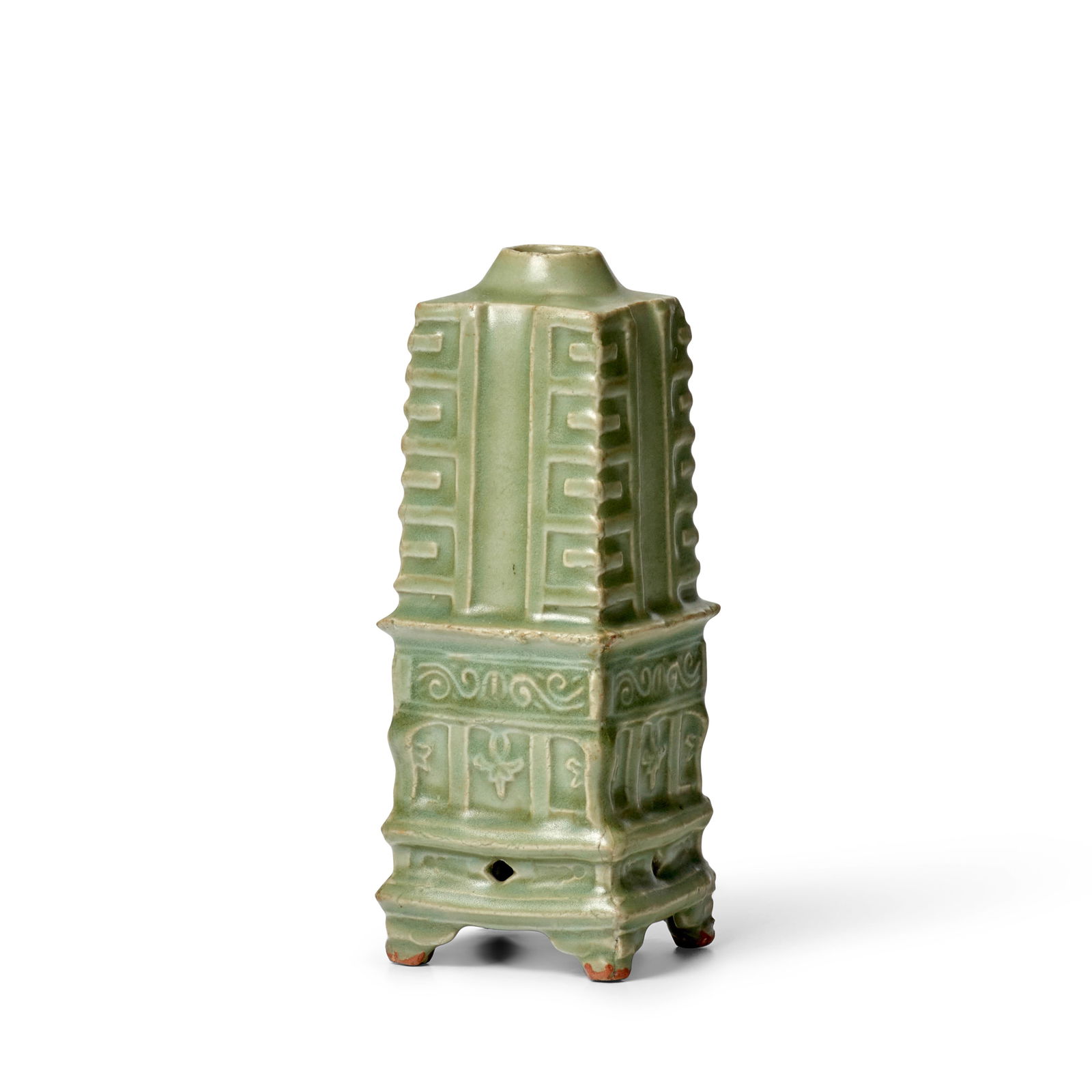 A LONGQUAN CELADON CONG-SHAPED VASE Southern Song/Yuan Dynasty: A LONGQUAN CELADON CONG-SHAPED VASE Southern Song/Yuan Dynasty Set on a tall stand and supported on four triangular feet, decorated with a scroll panel and flower pendants over an aperture on each sid