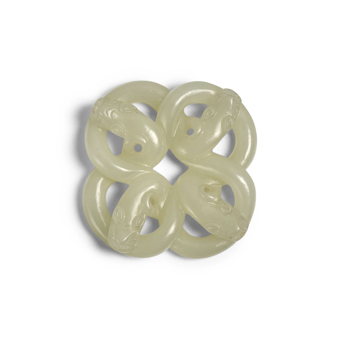 A WHITE JADE 'ENDLESS KNOT' SERPENT-FORM PENDANT Qing Dynasty or earlier: A WHITE JADE 'ENDLESS KNOT' SERPENT-FORM PENDANT Qing Dynasty or earlier Carved in open work depicting four chi dragons locked in a continuous loop, the translucent stone with even texture smoothly po