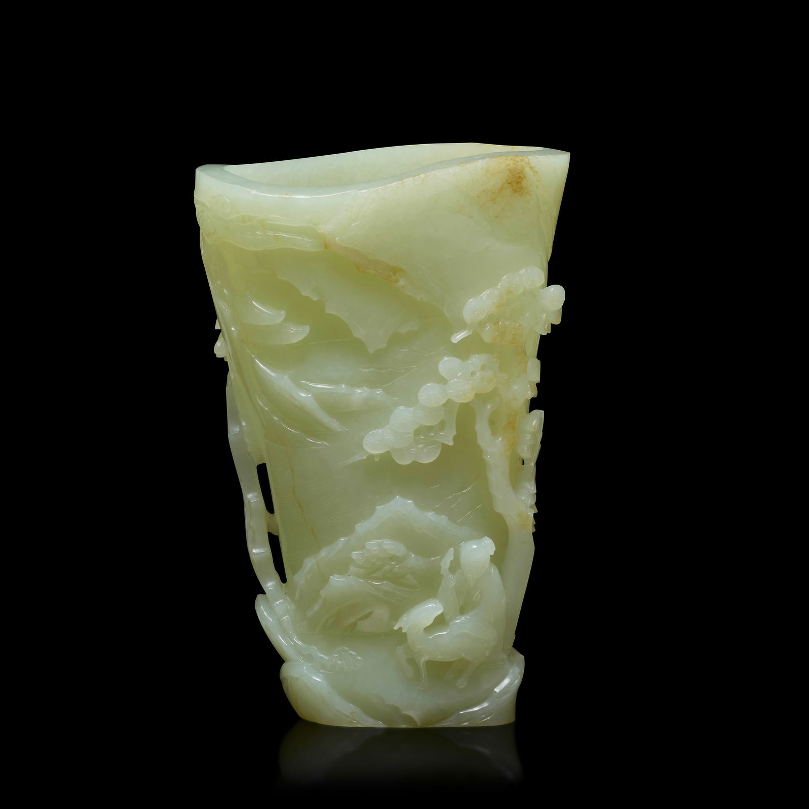 A PALE GREENISH-WHITE 'SHOULAO AND DEER' JADE LIBATION CUP 18th century: A PALE GREENISH-WHITE 'SHOULAO AND DEER' JADE LIBATION CUP 18th century Of irregular conical form, the exterior delicately carved in high relief to one side with shoulao and deer under a pine tree in