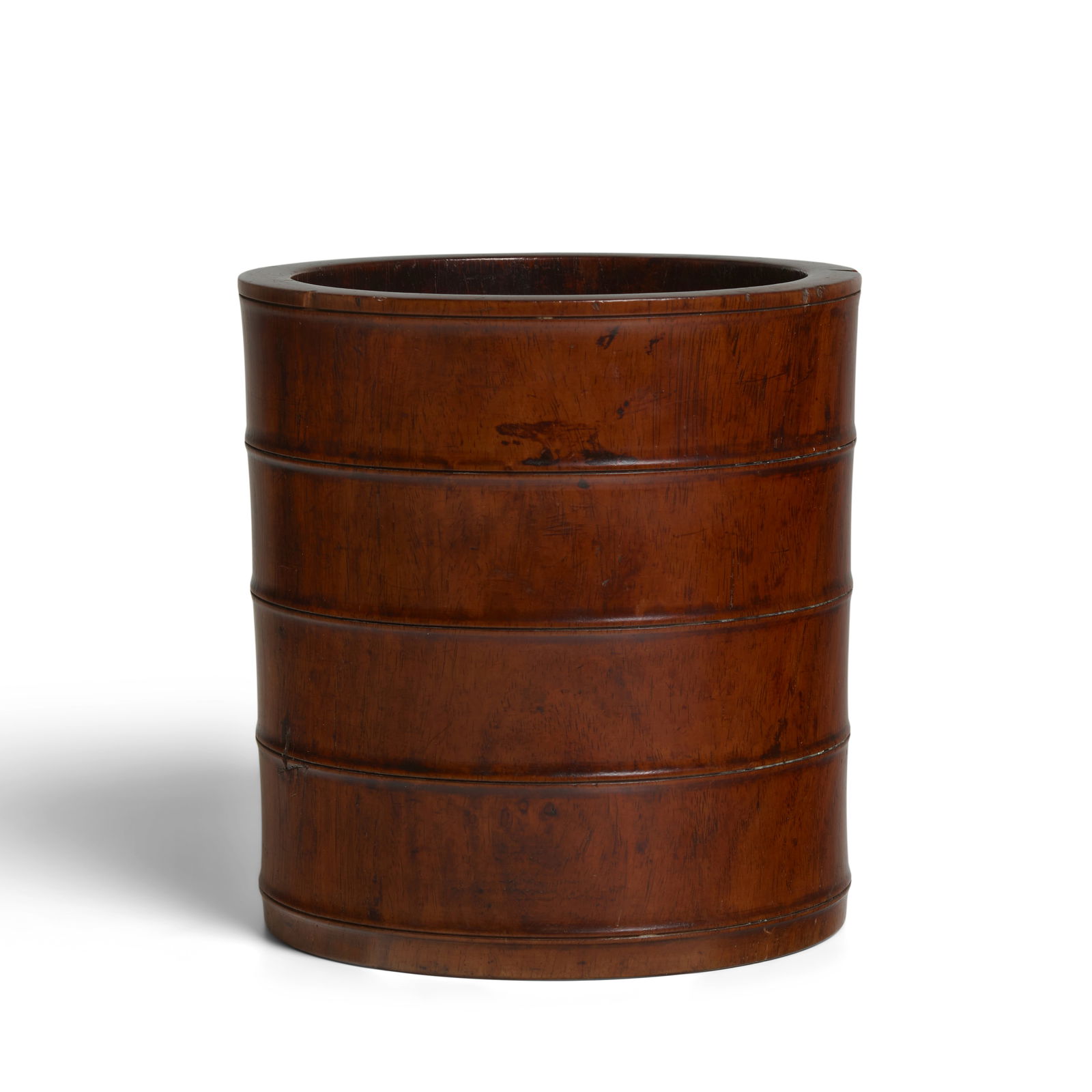 A FINE HUANGHUALI BAMBOO-FORM BRUSHPOT 18th/19th century: A FINE HUANGHUALI BAMBOO-FORM BRUSHPOT 18th/19th century The elegant cylindrical vessel carved with four double bow-strings simulating the sections of a large bamboo trunk, the surface exhibiting a ri