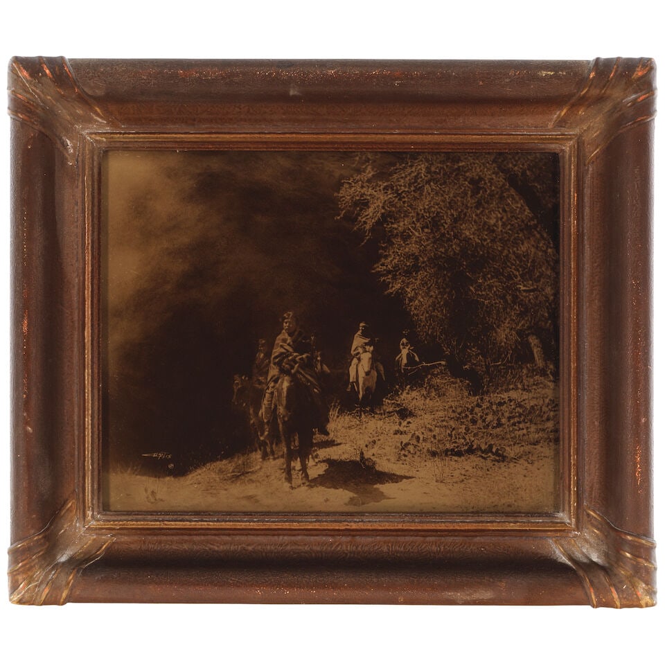 An Edward S. Curtis orotone, 'Out of the Darkness': Edward S. Curtis American, (1868-1952), 'Out of the Darkness,' orotone on glass framed in original Curtis Studio frame, signed in the image with copyright symbol lower left. sight: height 10 3/4in, wi