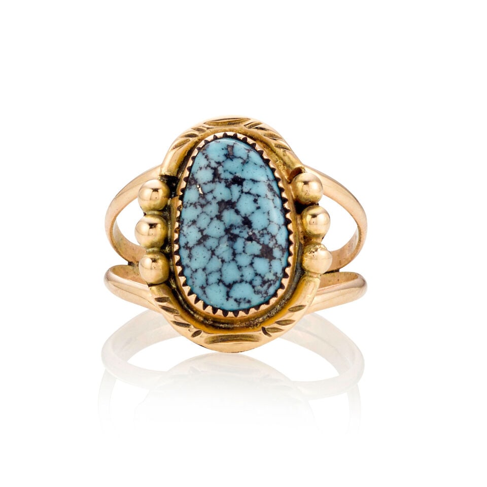 A Jim Myrtle gold and turquoise ring: Jim Myrtle Diné (Navajo), (20th/21st century), a 14k gold and Spiderweb Kingman turquoise split-shank ring, inscribed on interior: 14K. ring size 7 1/2; length 3/4in; gross weight approximately