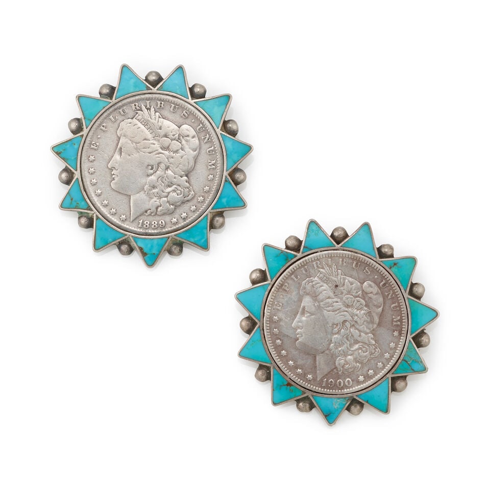 A pair of Zuni silver and turquoise pins: A pair of Zuni silver and turquoise pins Each designed with a Morgan silver dollar framed within a turquoise-inlaid sunburst surround with silver drop accents. each diameter 2 1/8in; gross weight
