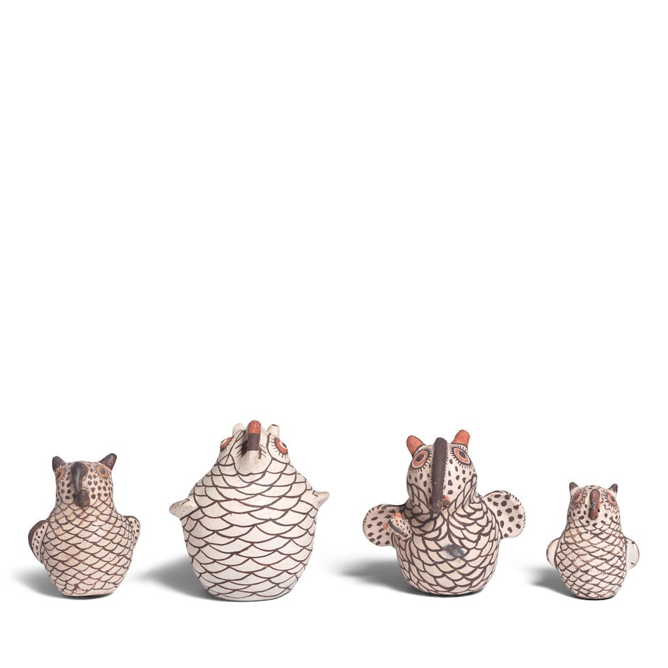 Four Zuni pottery owls: Four Zuni pottery owls Each painted in brown, cream and red/orange, the second-largest designed as a coin bank, with a baby emerging from under one wing and a worm clutched in the beak, each