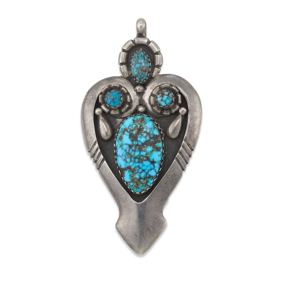 A Julian Lovato silver and turquoise pendant: Julian Lovato Kewa (Santo Domingo Pueblo), (1922-2018), a sterling silver pendant set with four turquoise, stamped verso with maker's marks and: Sterling / IHM. length 3 3/8in, width 1 3/4in; gross we