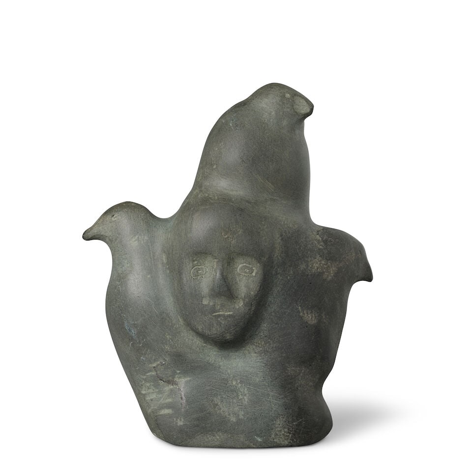 A Tuna Iquliq carved stone sculpture: Tuna Iquliq Inuit, Qamani'tuaq (Baker Lake), (1935-2015), a carved stone sculpture, carved in the round with birds and emerging human faces, signed in syllabics on the underside and numbered: 54799 /
