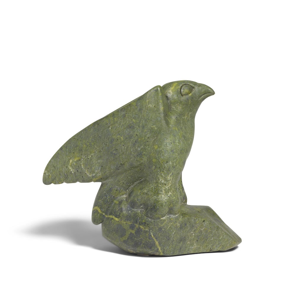 A Joanassie Igiu stone sculpture: Joanassie Igiu Inuit, Cape Dorset / Kinngait, (1923-1981), Untitled, carved stone sculpture of a hawk, signed in syllabics and with artist's disc number at the base. height 14in, length 18 1/2in For