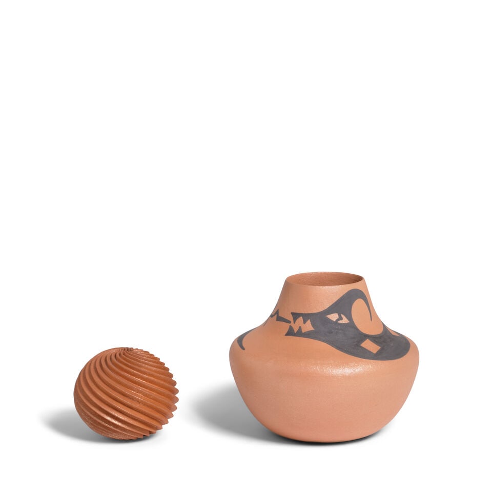 Two Pueblo micaceous pottery vessels: Two Pueblo micaceous pottery vessels A spiral carved example by Hubert Candelario, (San Felipe, b. 1965), dated 1.22.2004; and a jar with Avanyu motif by Alan Lasiloo, (Zuni, b. 1969). Candelario: