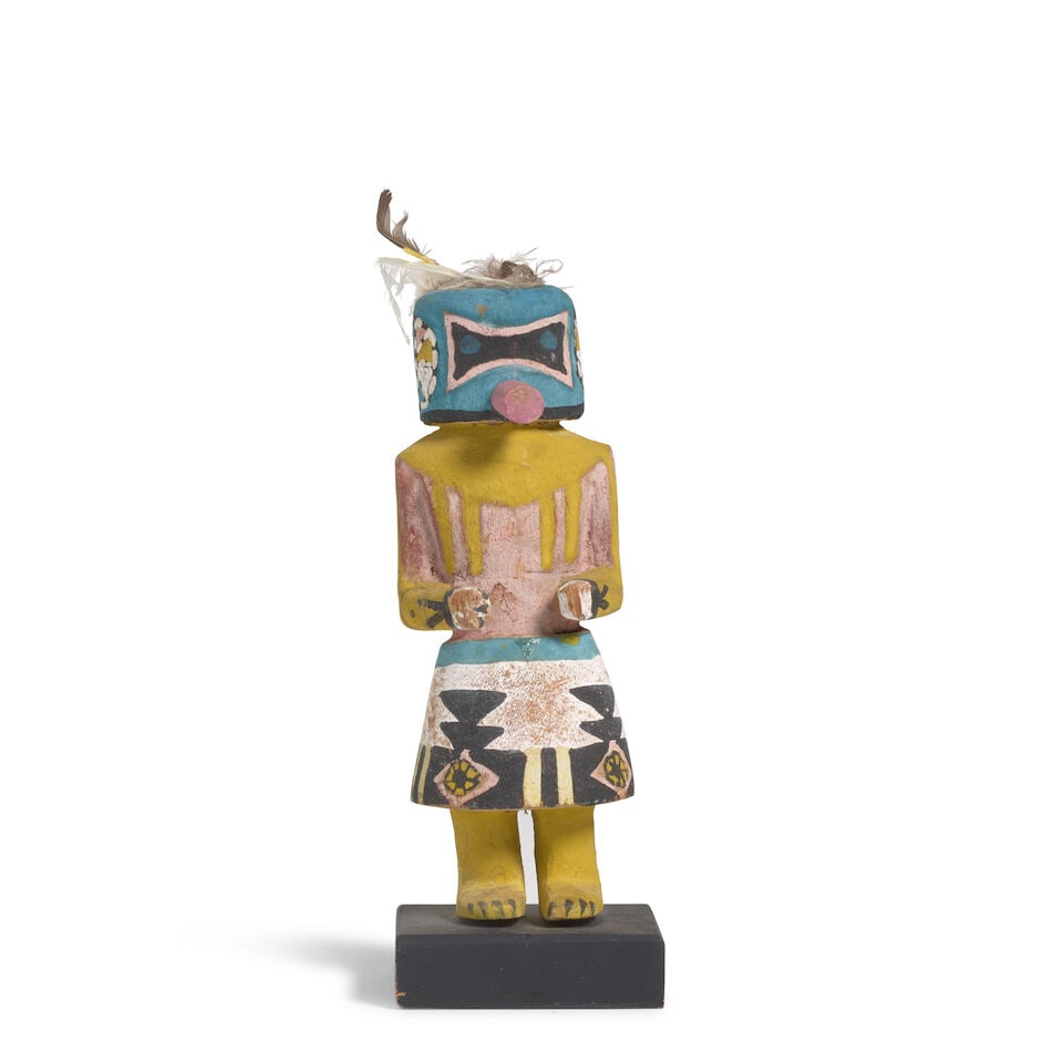 A Hopi katsina figure: A Hopi katsina figure Depicting Sip-ikne, or Zuni Warrior katsina, on a custom wood base. height (excluding base) 6 3/4in For further information on this lot please visit Bonhams.com For further
