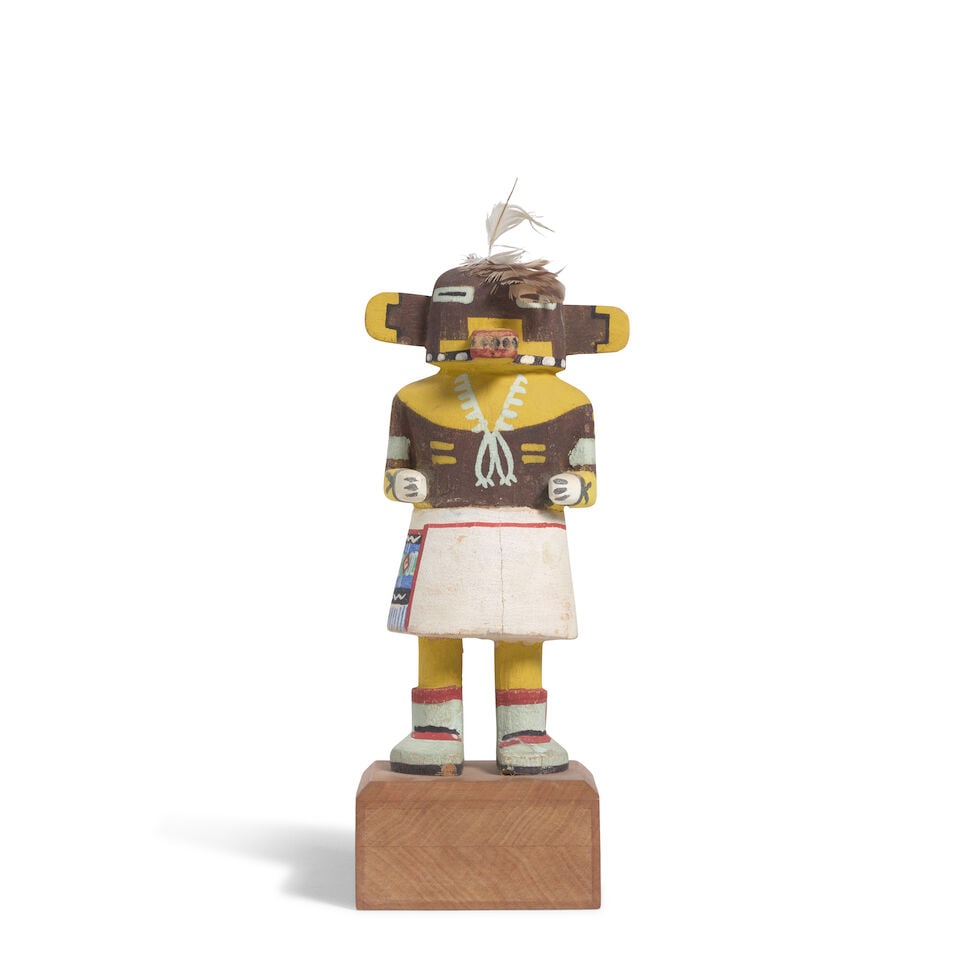 A Hopi katsina figure: A Hopi katsina figure Possibly depicting Manangya, or Lizard katsina, on a custom wood base. height (excluding base) 6 1/2in For further information on this lot please visit Bonhams.com For further