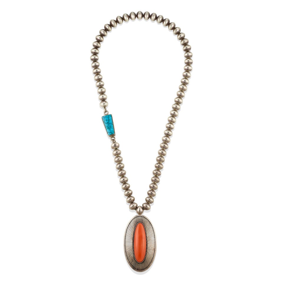 An Al Nez silver, coral and turquoise necklace: Al Nez Diné (Navajo), (b. 1959), a silver bead necklace, the clasp set with turquoise, the heavy pendant centering an oval-shaped coral within a radiating abstract feather surround, the pendant