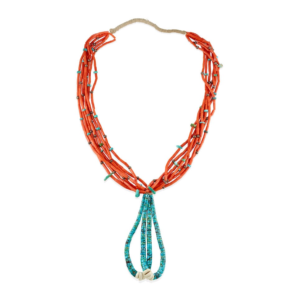 A Pueblo multi-strand necklace: A Pueblo multi-strand necklace A seven-strand coral, turquoise and silver bead necklace suspending a large pair of turquoise and shell jaclas. wearable length 28 1/2in, each jacla length 5 1/8in This