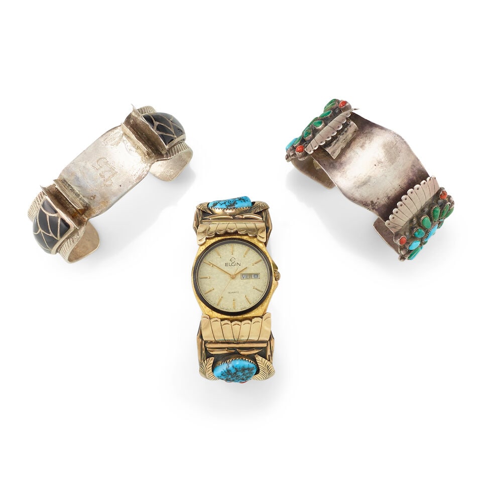 Three Diné (Navajo) or Zuni watch cuffs: Three Diné (Navajo) or Zuni watch cuffs Each of silver, comprising a coral and turquoise cluster example stamped on interior: S.B.; a channel-inlaid onyx example stamped on interior for Emma Bonn