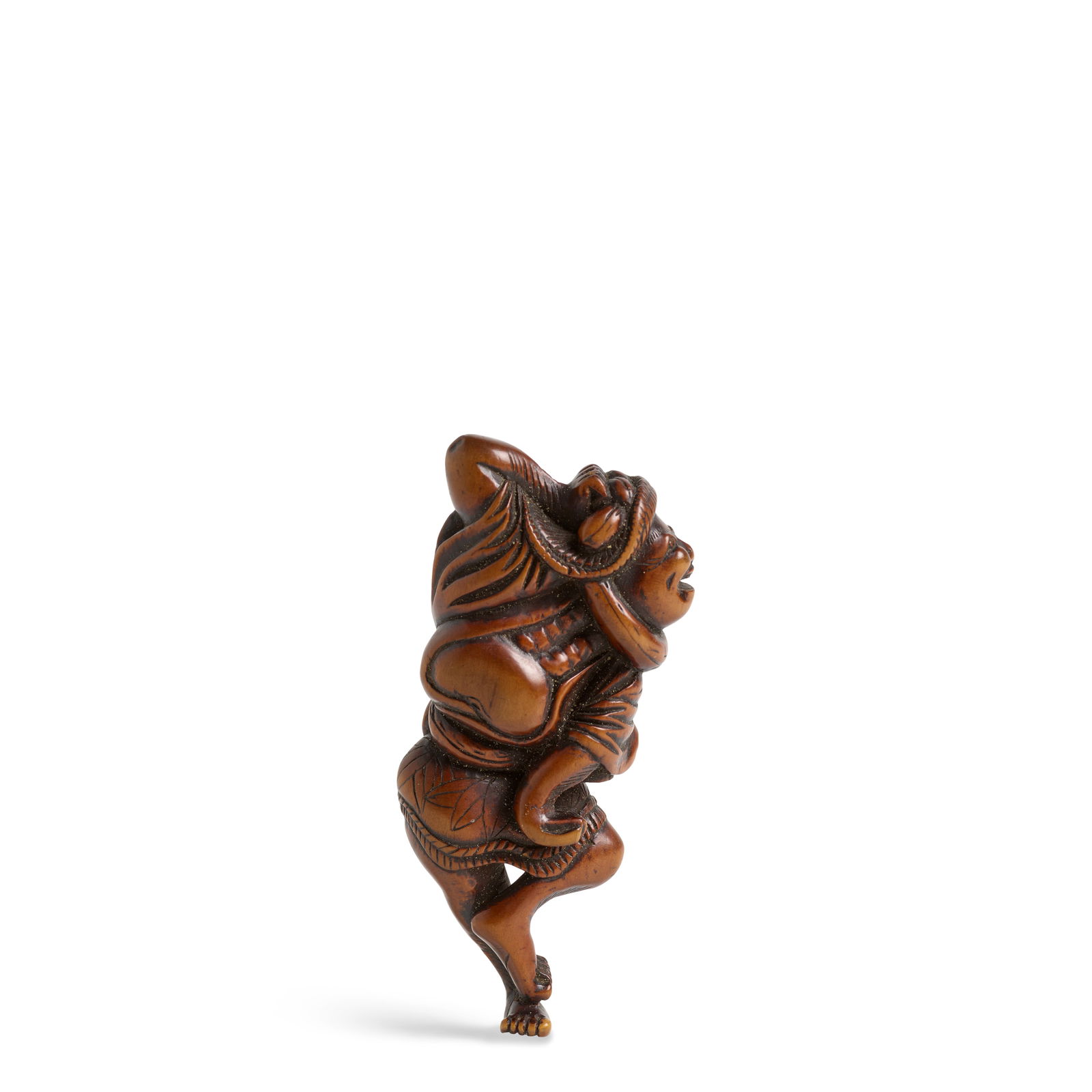 A LARGE WOOD NETSUKE OF A DANCING KUMOSUKE (PORTER) Edo period (1615-1868), 18th century: A LARGE WOOD NETSUKE OF A DANCING KUMOSUKE (PORTER) Edo period (1615-1868), 18th century Carved as a porter balanced on one foot in an animated pose, dressed in a loincloth, an apron, and a short jack