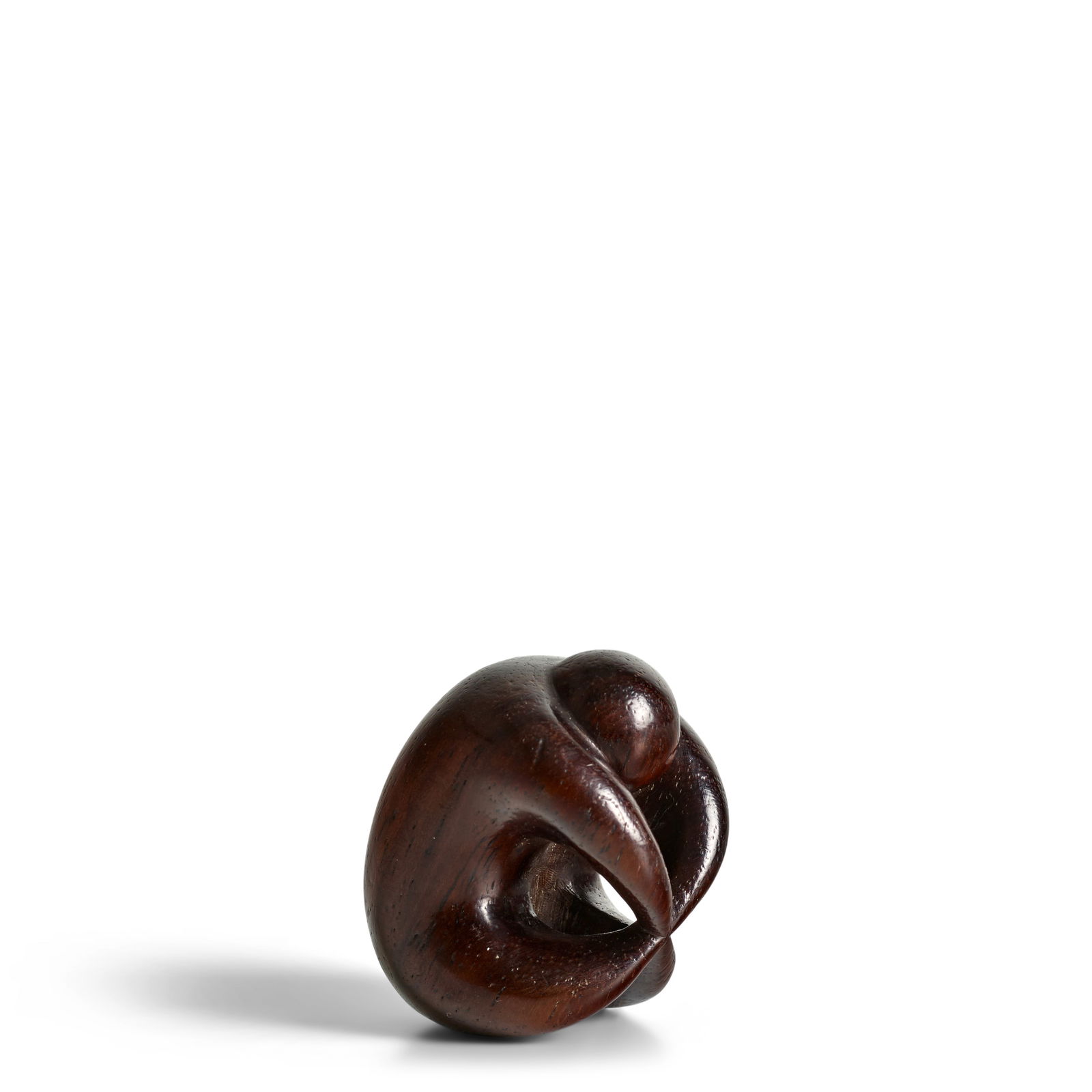 MIWA (ACTIVE LATE 18TH/EARLY 19TH CENTURY) A Wood Netsuke of a Sarubobo (Monkey Doll) Edo period...: MIWA (ACTIVE LATE 18TH/EARLY 19TH CENTURY) A Wood Netsuke of a Sarubobo (Monkey Doll) Edo period (1615-1868), 18th/19th century Carved in dark wood as a stylized sarubobo, the surface bearing a soft,