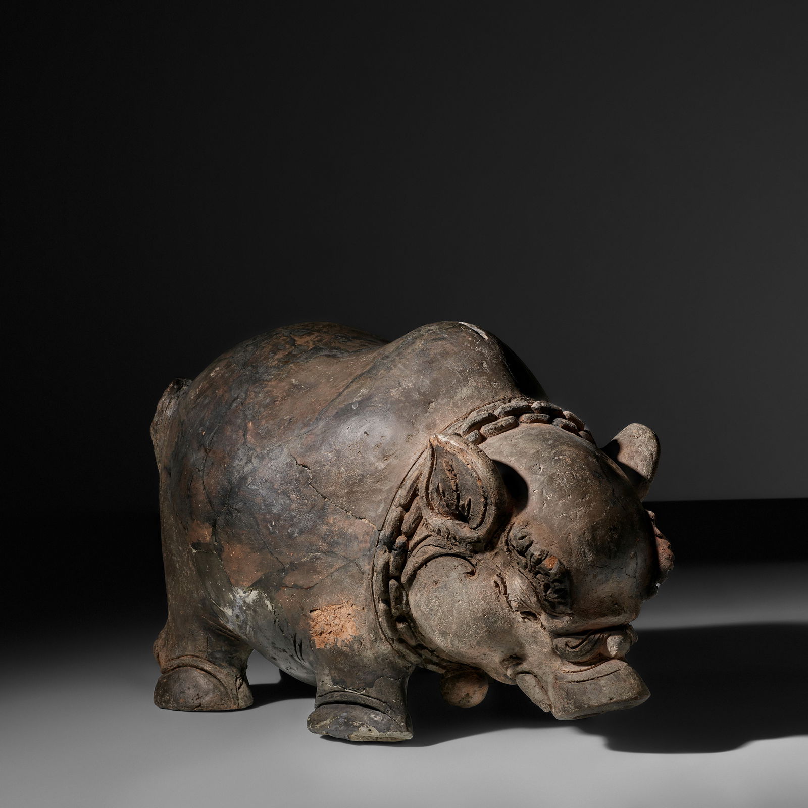 A TERRACOTTA BOAR-SHAPED MONEY BOX INDONESIA, EASTERN JAVA, MAJAPAHIT KINGDOM, 15TH CENTURY: A TERRACOTTA BOAR-SHAPED MONEY BOX INDONESIA, EASTERN JAVA, MAJAPAHIT KINGDOM, 15TH CENTURY 15 1/2 in. (39.4 cm) high 22 in. (55.9 cm) long Footnotes: 印度尼西亞 東