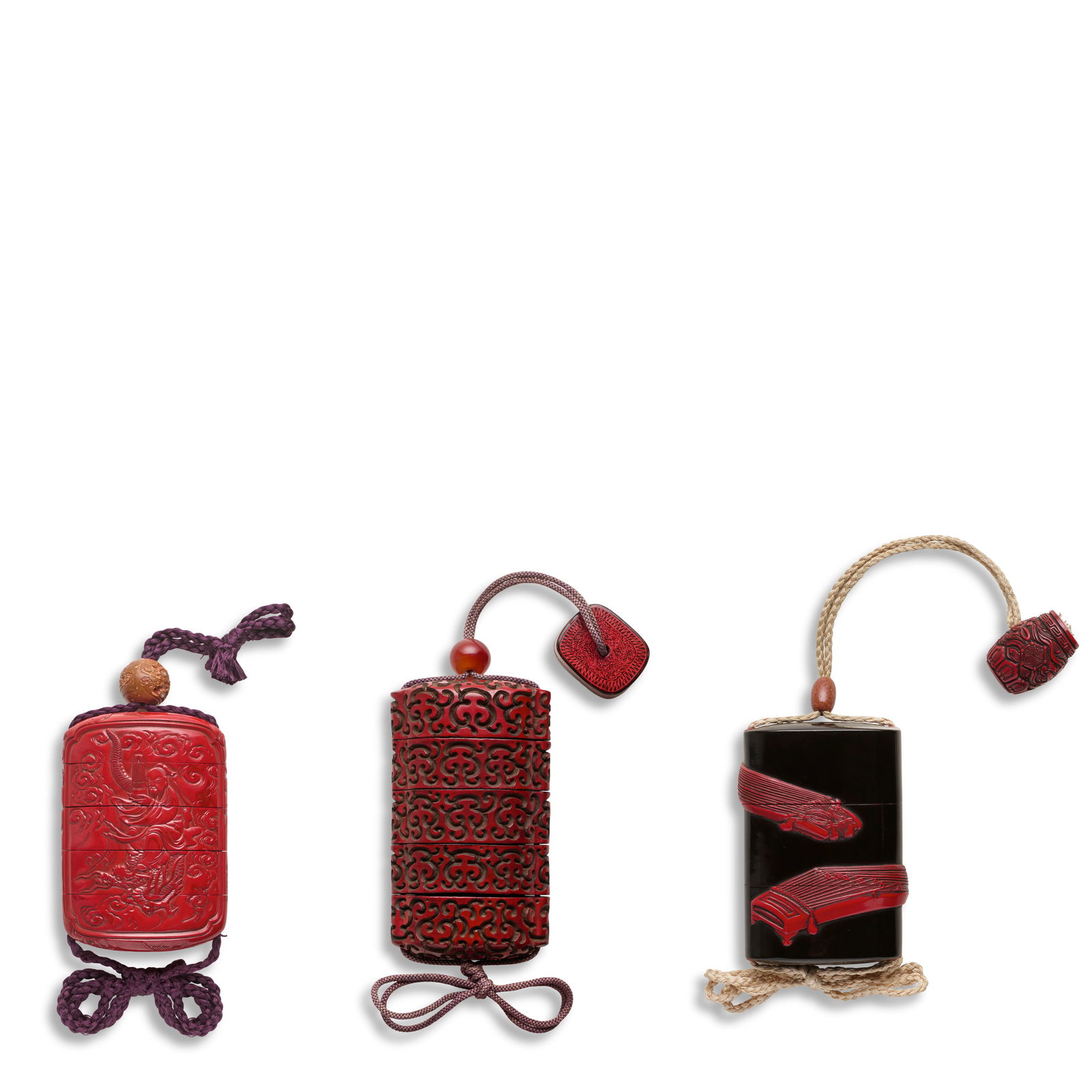 THREE CARVED RED LACQUER INRŌ (MEDICINE CONTAINERS) Edo period (1615-1868), 19th century (3): THREE CARVED RED LACQUER INRŌ (MEDICINE CONTAINERS) Edo period (1615-1868), 19th century The first of rounded rectangular plan with integral himotōshi, two cases, the black lacquer ground ap