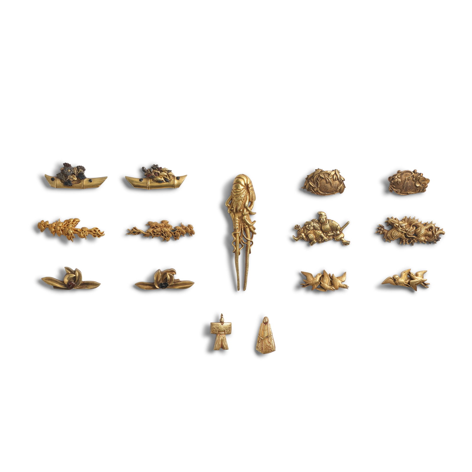 SIX PAIRS OF GOLD MENUKI (HILT GRIPS), A GILT PAIR OF MENUKI, AND A SINGLE GOLD MENUKI Edo peri...: SIX PAIRS OF GOLD MENUKI (HILT GRIPS), A GILT PAIR OF MENUKI, AND A SINGLE GOLD MENUKI Edo period (1615-1868), 18th/19th century Comprising a gold, silver, shakudō, and copper pair each in the fo