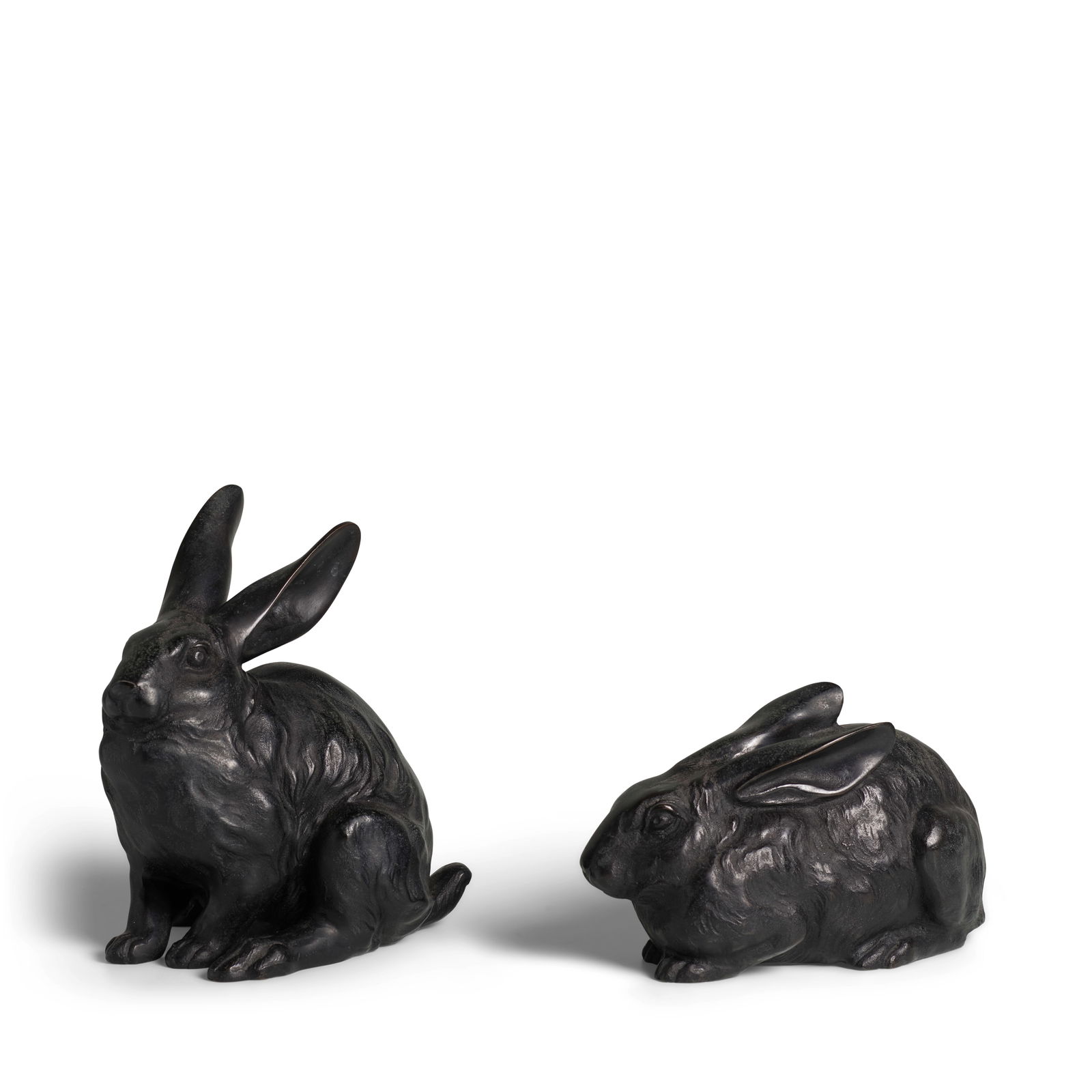 SHŪZAN (ACTIVE CIRCA 1900) A Pair of Bronze Models of Rabbits Meiji era (1868-1912), circa ...: SHŪZAN (ACTIVE CIRCA 1900) A Pair of Bronze Models of Rabbits Meiji era (1868-1912), circa 1900 One seated on its haunches with ears slightly extended, the other crouching with ears pressed again