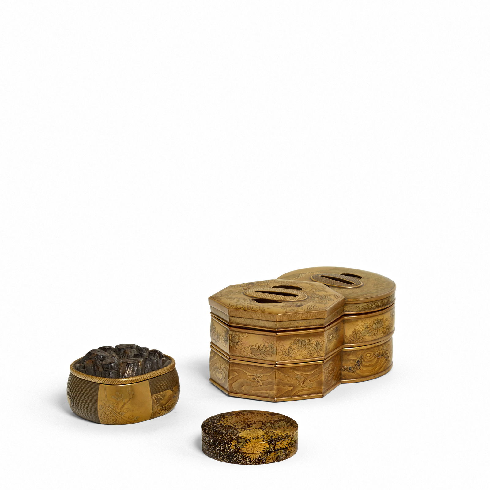 THREE LACQUER BOXES Meiji era (1868-1912), late 19th/early 20th century (3): THREE LACQUER BOXES Meiji era (1868-1912), late 19th/early 20th century Comprising a two-tier stacking box formed as two overlapping tsuba (hand guards) with a kinji ground, decorated in two shades of